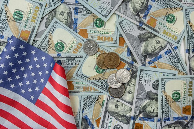 Billetes de dólar y monedas sobre una superficie plana.